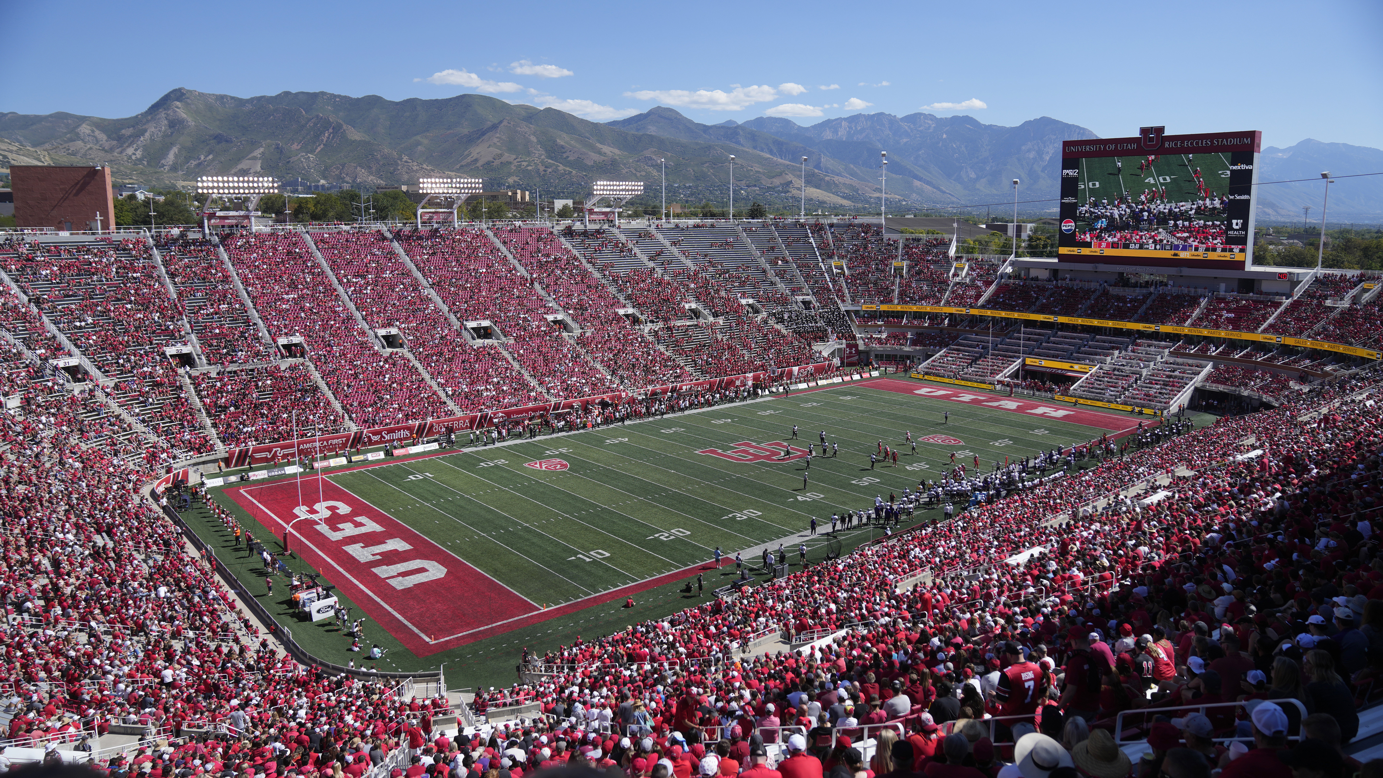 FILE - Weber State and Utah play during an NCAA college football game Rice-Eccles Stadium on Sept. 16, 2023, in Salt Lake City. College athletes in Utah who are looking to profit off their name, image and likeness will have to seek written approval from their school for any business deal exceeding $600 under a bill that received final legislative approval Friday, March 1, 2024, in the state Senate. 