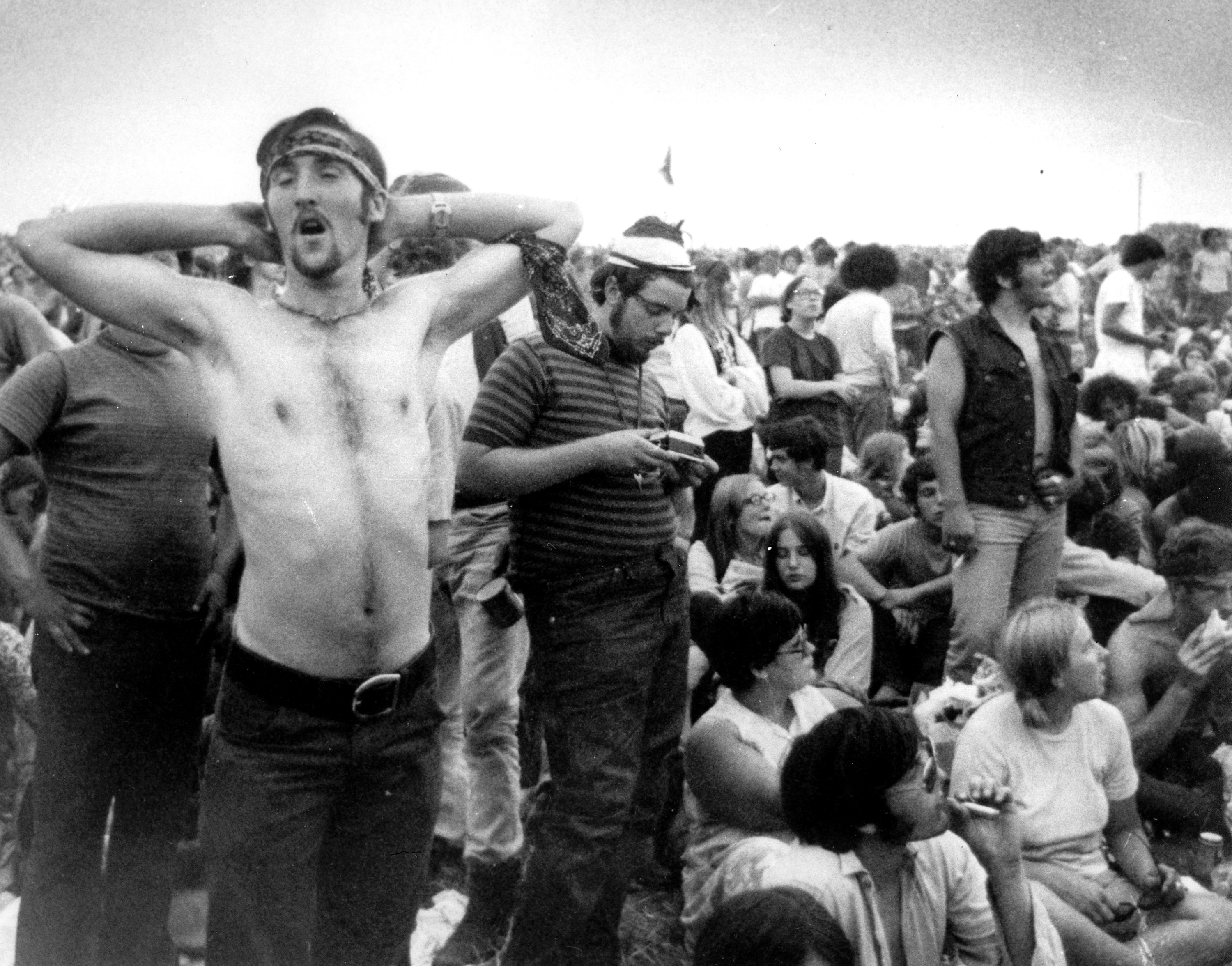 Music fans relax during a break in the entertainment at the Woodstock Music and Arts Fair, Aug. 16, 1969, in Bethel, N.Y. An estimated 450,000 people attended the festival, and most were teenagers or young adults now in the twilight of their lives.