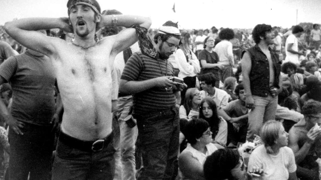 Music fans relax during a break in the entertainment at the Woodstock Music and Arts Fair, Aug. 16, 1969, in Bethel, N.Y. An estimated 450,000 people attended the festival, and most were teenagers or young adults now in the twilight of their lives.