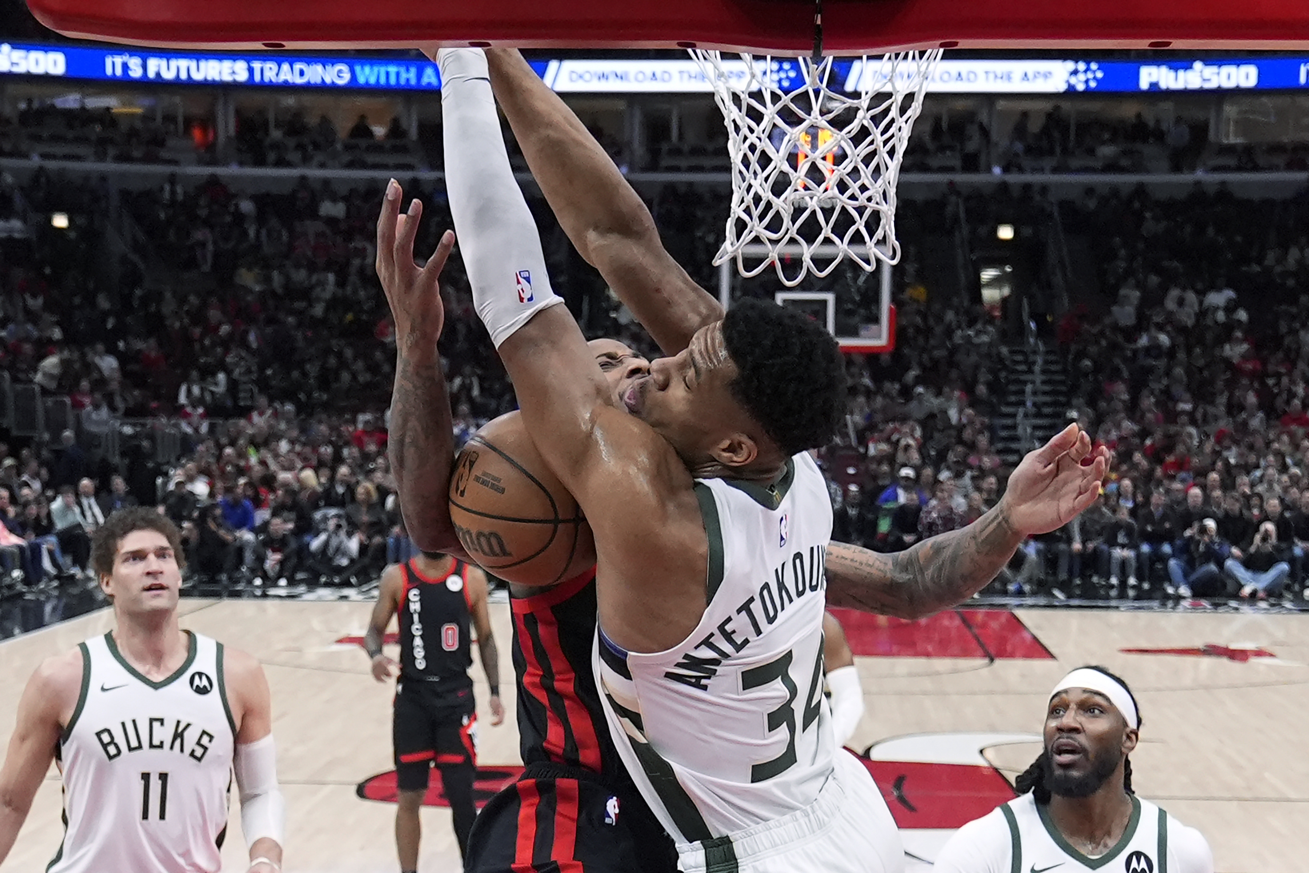 Chicago Bulls' DeMar DeRozan collides with Milwaukee Bucks' Giannis Antetokounmpo under the basket during the first half of an NBA basketball game Friday, March 1, 2024, in Chicago. 