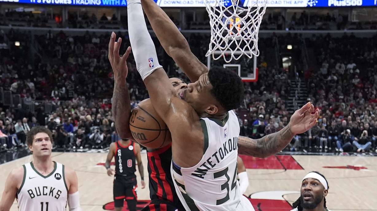 Chicago Bulls' DeMar DeRozan collides with Milwaukee Bucks' Giannis Antetokounmpo under the basket during the first half of an NBA basketball game Friday, March 1, 2024, in Chicago.