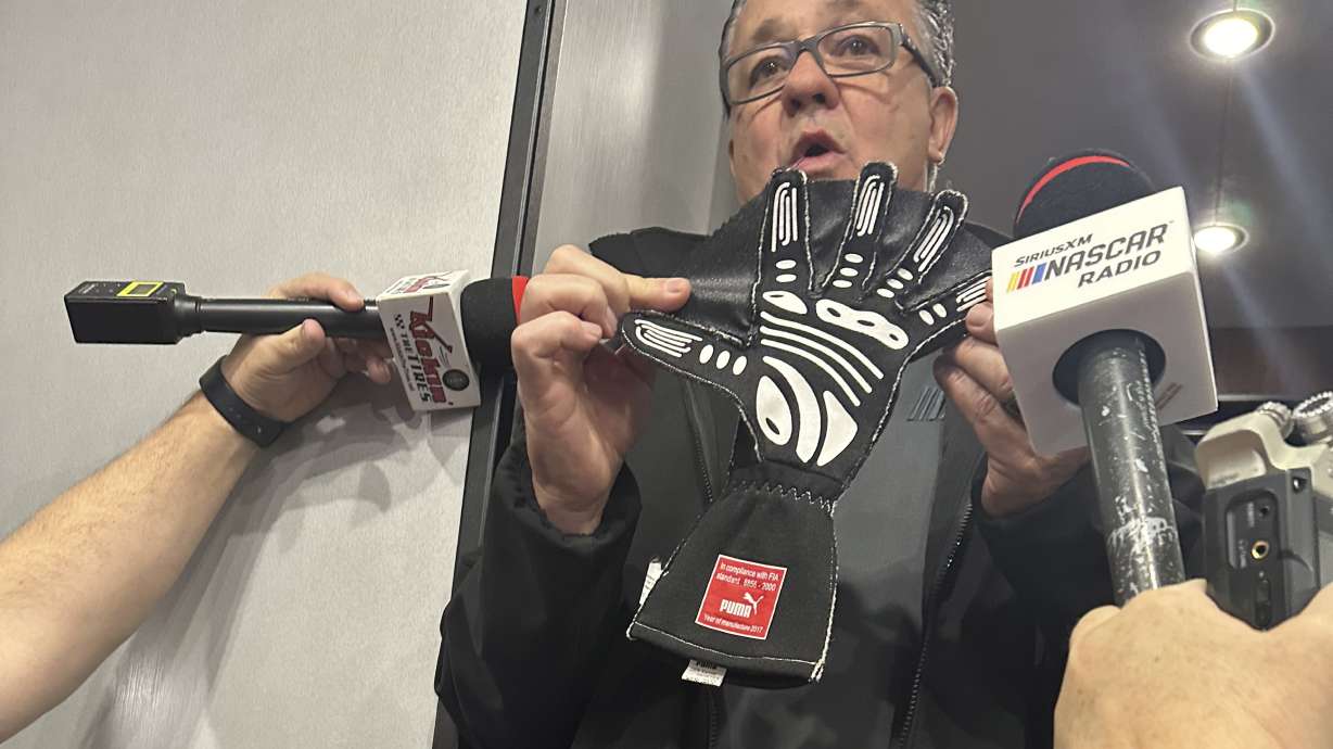 NASCAR Cup Series Managing Director Brad Moran shows reporters, Saturday, March 2, 2024, at Las Vegas Motor Speedway, the illegal glove Joey Logano of Team Penske was caught wearing during qualifying last week at Atlanta Motor Speedway. The webbing between the fingers that give the glove a “Spider-Man” appearance are used to block air when a driver puts his hand out the window during qualifying.