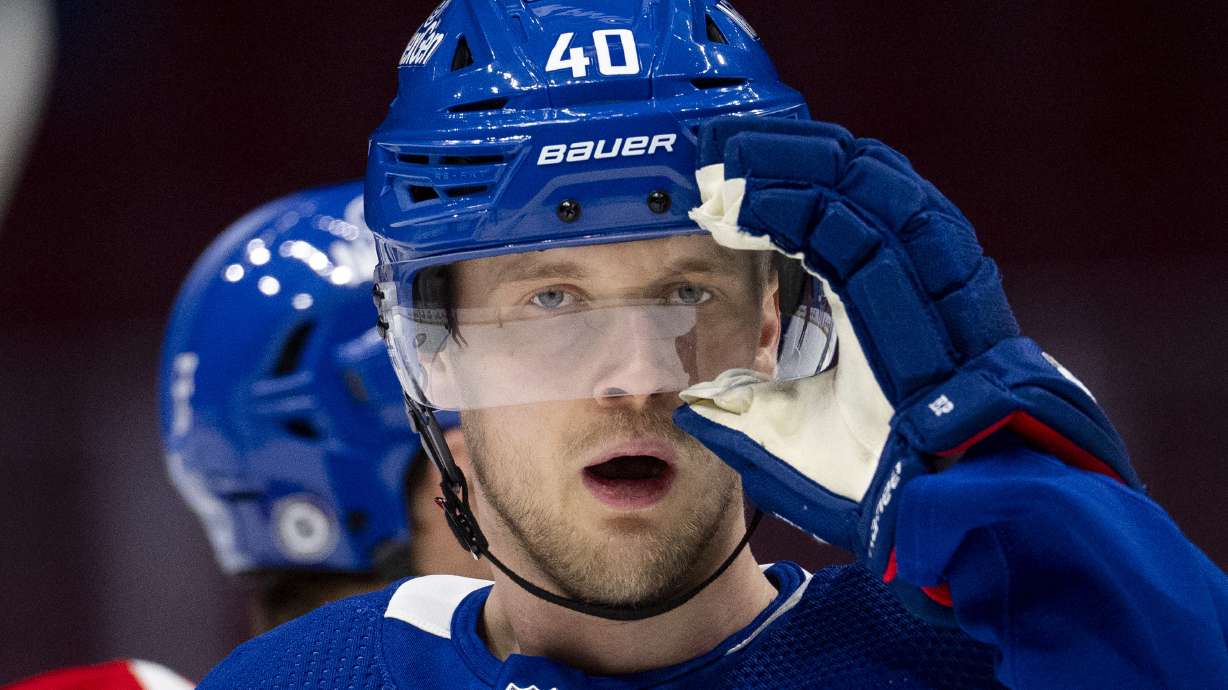 Vancouver Canucks' Elias Pettersson adjusts his helmet during an NHL hockey practice in Vancouver, British Columbia on Saturday, March 2, 2024. Pettersson resigned to the team with an eight year contract extension.