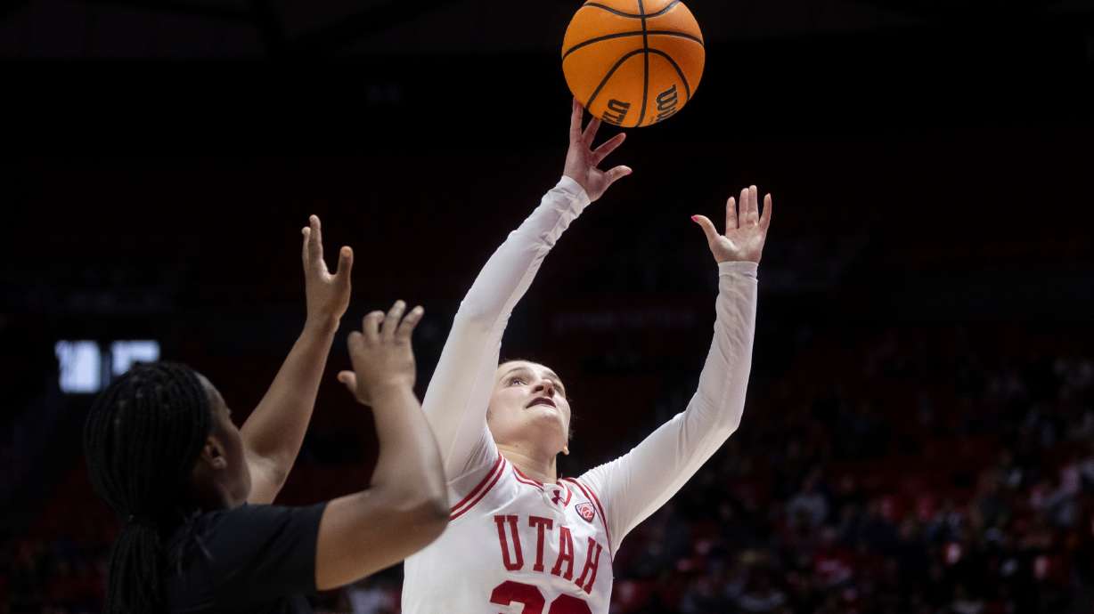 Utah Utes guard Matyson Wilke (23) shoots the ball over Washington Huskies guard Sayvia Sellers (0) at the Hunstman Center in Salt Lake City on Saturday, March 2, 2024.