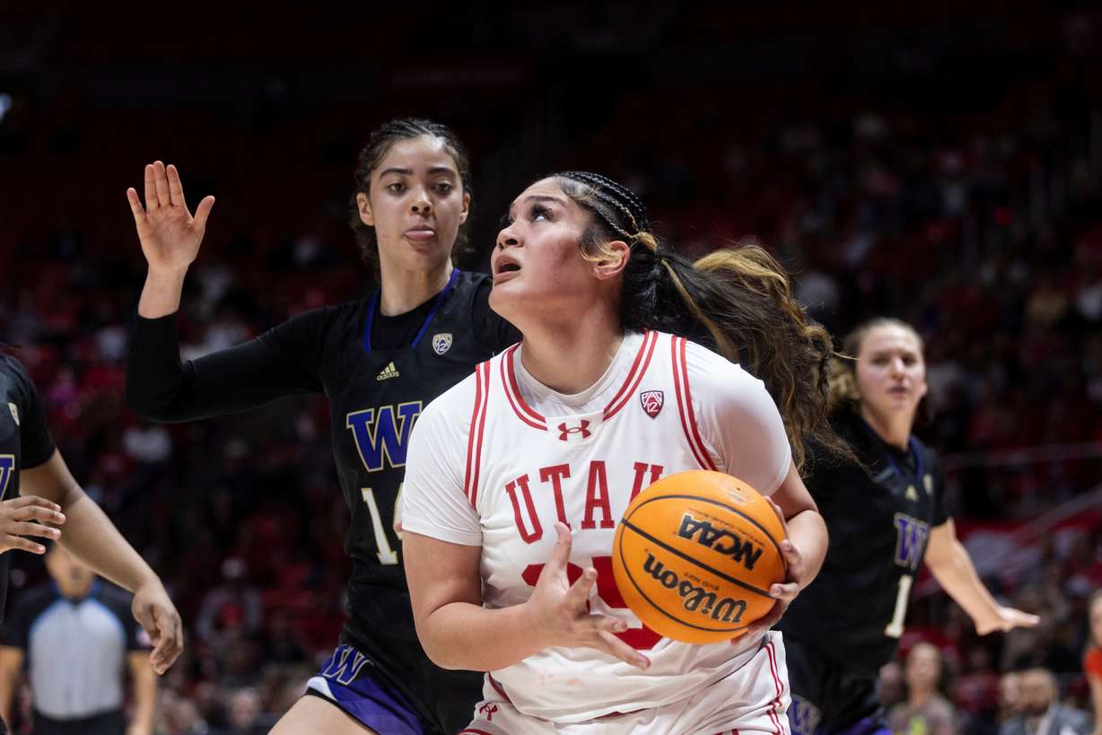 Utah Utes forward Alissa Pili (35) looks to shoot the ball while Washington Huskies forward Dalayah Daniels (14) posts up against her at the Hunstman Center in Salt Lake City on Saturday, March 2, 2024.