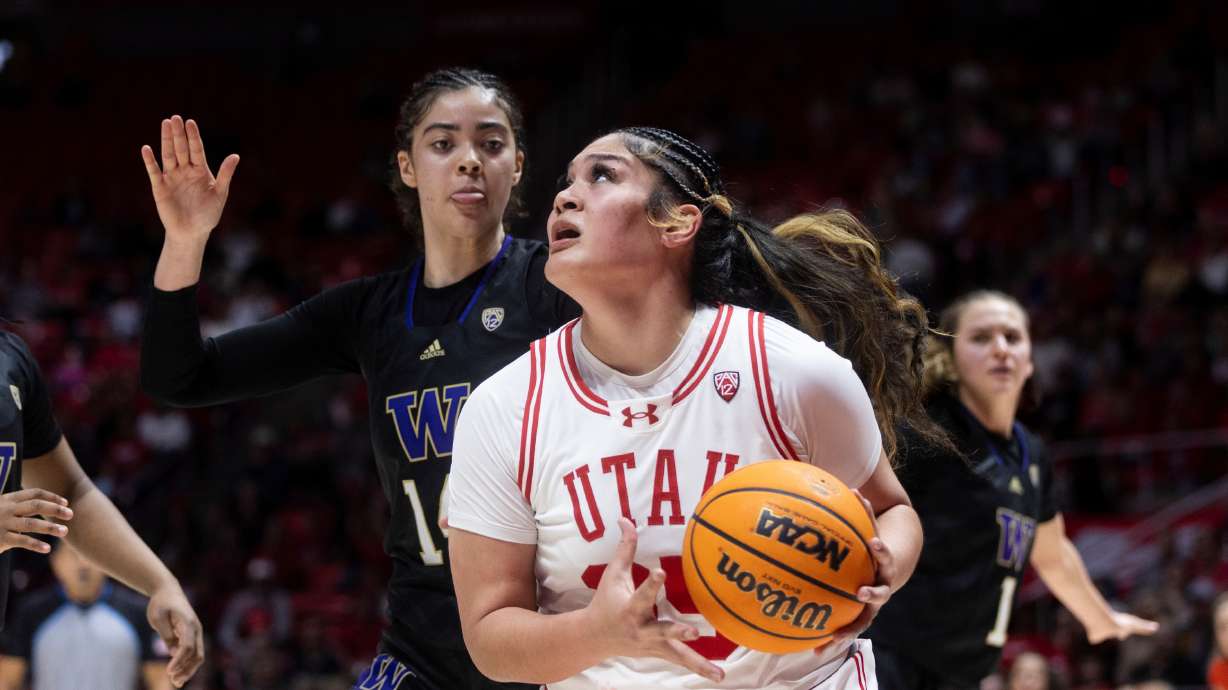 Utah Utes forward Alissa Pili (35) looks to shoot the ball while Washington Huskies forward Dalayah Daniels (14) posts up against her at the Hunstman Center in Salt Lake City on Saturday, March 2, 2024.