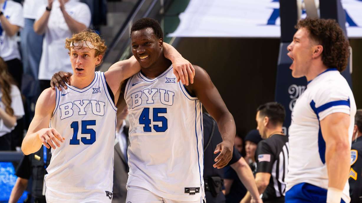 Brigham Young Cougars guard Richie Saunders (15) and Brigham Young Cougars forward Fousseyni Traore (45) walk off the court with their arms around each other following their 87-75 victory in the college men’s basketball game against the TCU Horned Frogs at the Marriott Center in Provo on Saturday, March 2, 2024.
