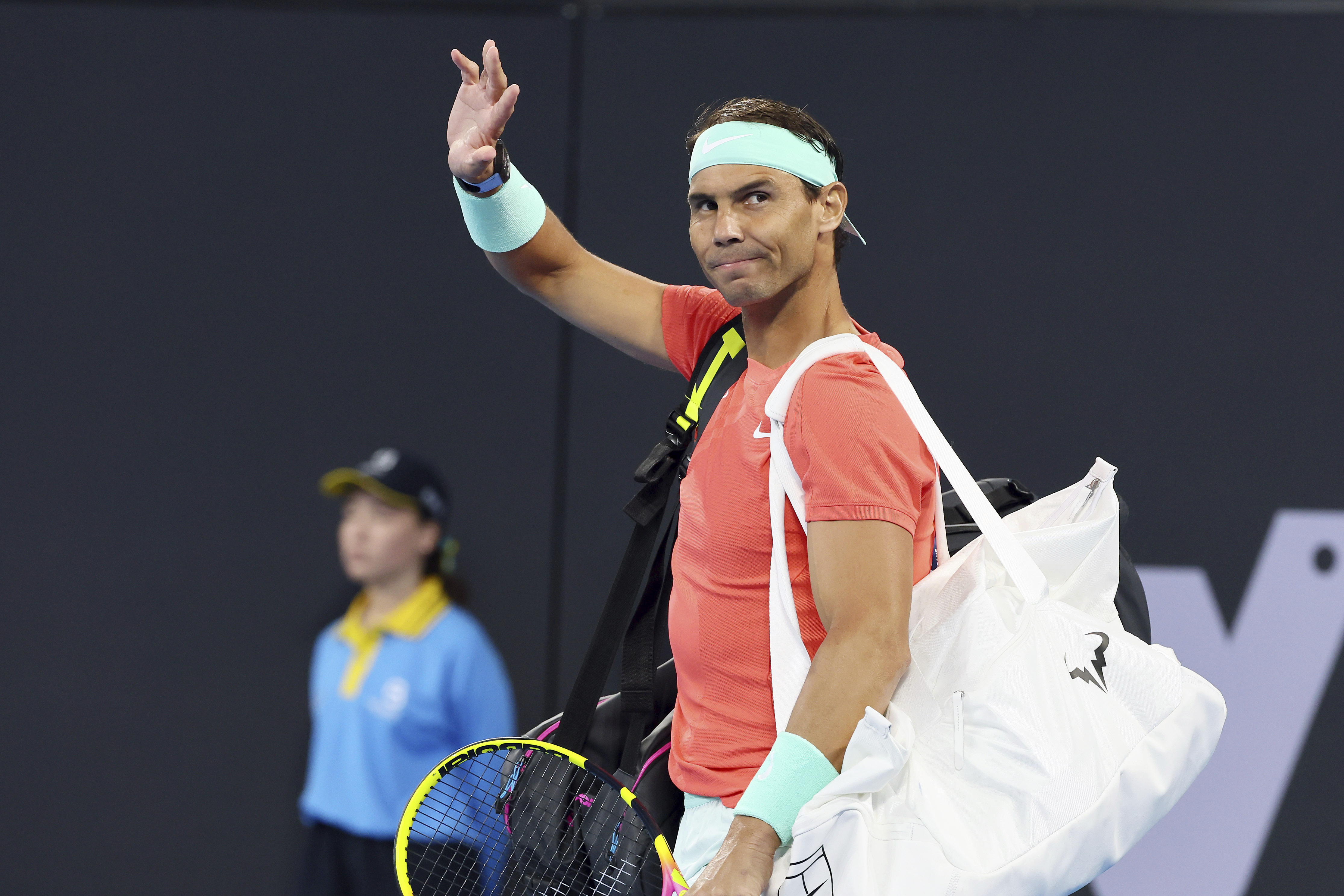 FILE - Rafael Nadal, of Spain, waves to the crowd at his doubles match against Australia's Max Purcell and Jordan Thompson during the Brisbane International tennis tournament in Brisbane, Australia, Dec. 31, 2023. Nadal played an unofficial event Sunday, March 3, 2024, losing to fellow Spaniard Carlos Alcaraz 3-6, 6-4 (14-12) in The Netflix Slam in Las Vegas. 