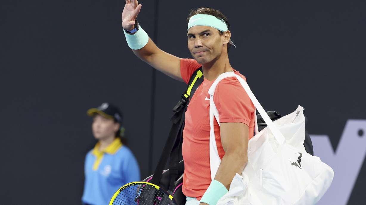 FILE - Rafael Nadal, of Spain, waves to the crowd at his doubles match against Australia's Max Purcell and Jordan Thompson during the Brisbane International tennis tournament in Brisbane, Australia, Dec. 31, 2023. Nadal played an unofficial event Sunday, March 3, 2024, losing to fellow Spaniard Carlos Alcaraz 3-6, 6-4 (14-12) in The Netflix Slam in Las Vegas.