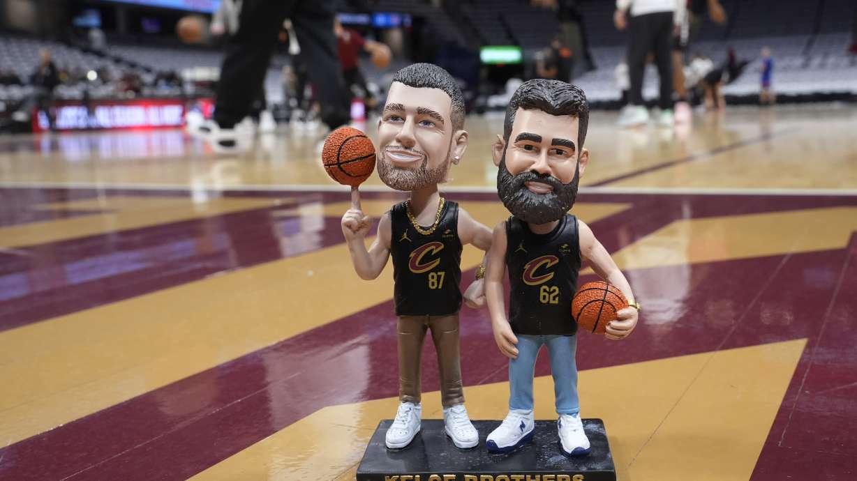 A bobblehead of Cleveland natives Travis and Jason Kelce stands on the Cleveland Cavaliers' court Sunday, March 3, 2024, in Cleveland. The team will give the bobbleheads to fans at an NBA basketball game against the Boston Celtics, Tuesday, March 5.
