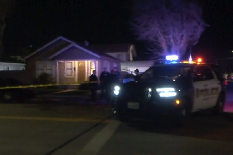 Police investigate the scene of a shooting in King City, Calif., Sunday. Police say a group of men in masks opened fire at an outdoor party in central California on Sunday.  