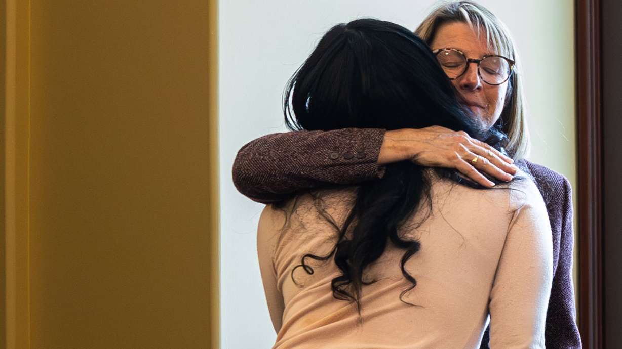Left to right, Sinia Maile, whose second cousin Paul Tahi was killed in a shooting near Hunter High School, hugs Nancy Halden, communications director for Gun Violence Prevention Center, at a press conference at the Capitol in Salt Lake City on Monday.