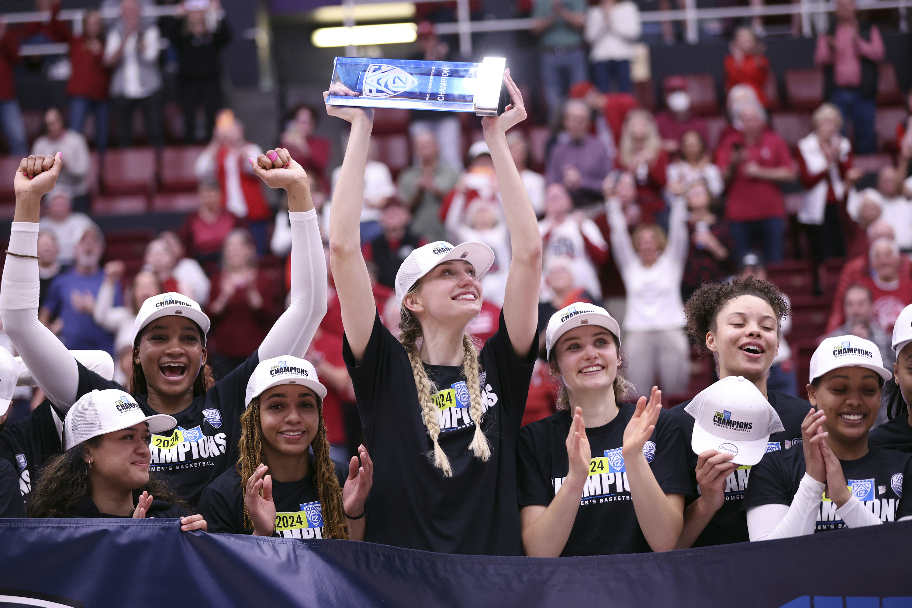 Stanford senior Cameron Brink holds up the Pac 12 conference championship trophy after the Cardinal's 81-67 win over Arizona State in the NCAA college basketball in Stanford, Calif., Sunday, Feb. 25, 2024.