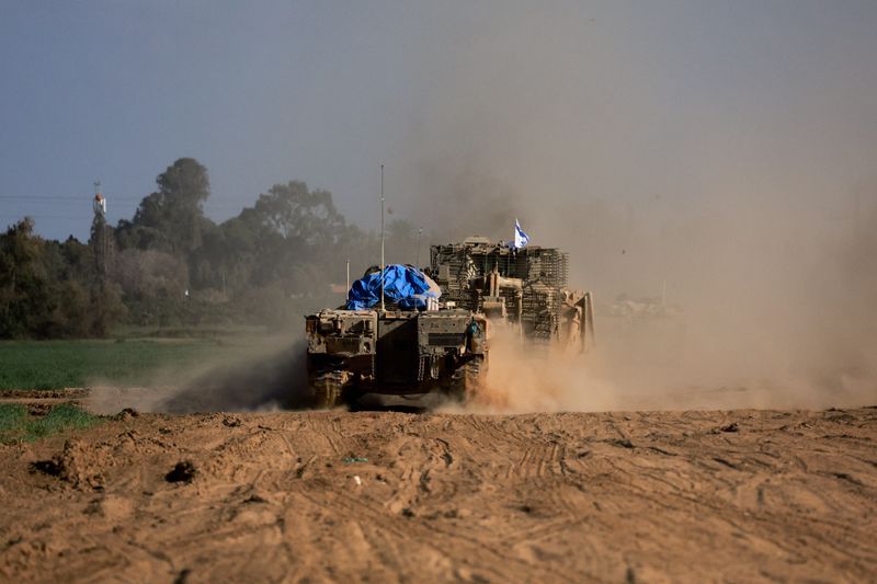 Military vehicles maneuver near the Israel-Gaza border, amid the ongoing conflict between Israel and the Palestinian Islamist group Hamas, in Israel, Monday.