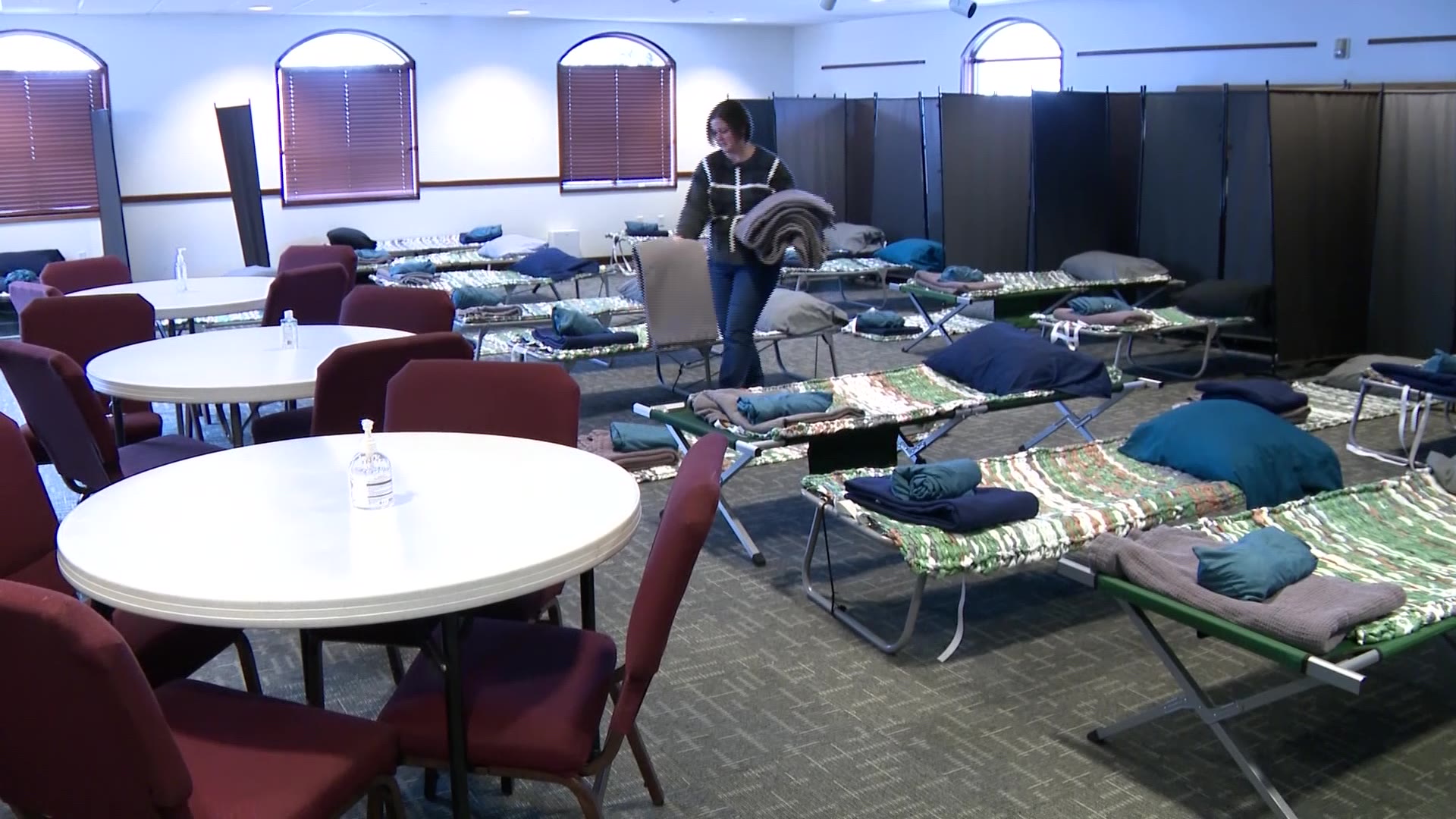 Christine Runhaar prepares beds for visitors. A Logan warming center is asking for more volunteers and resources as the area is hit by another Code Blue warning.