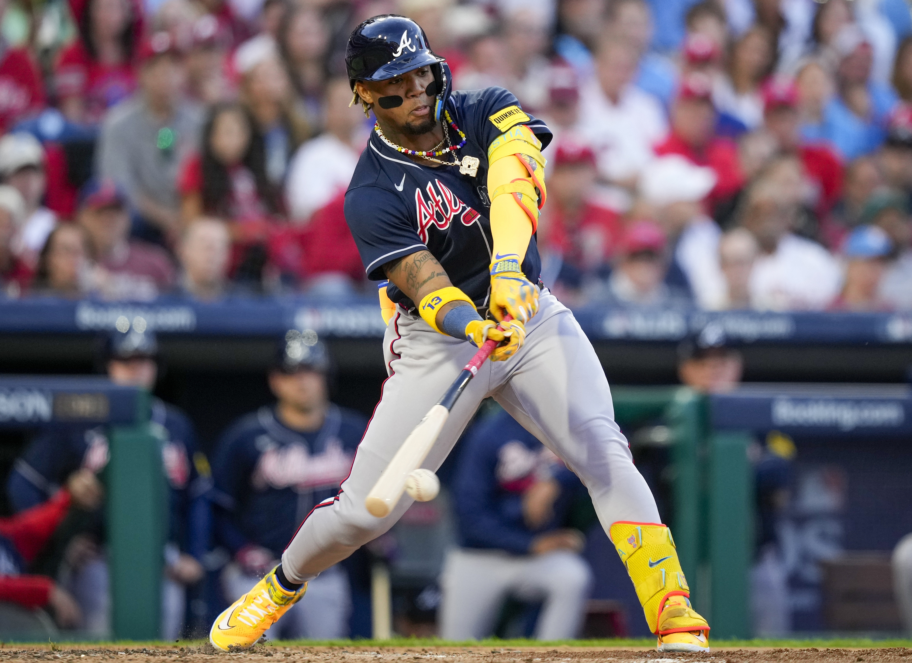 FILE - Atlanta Braves' Ronald Acuna Jr. hits a double during the third inning of Game 3 of a baseball NL Division Series against the Philadelphia Phillies, Oct. 11, 2023, in Philadelphia. This season, the Braves and stars like Acuna will try to finish the job after a disappointing early exit in last year's playoffs.