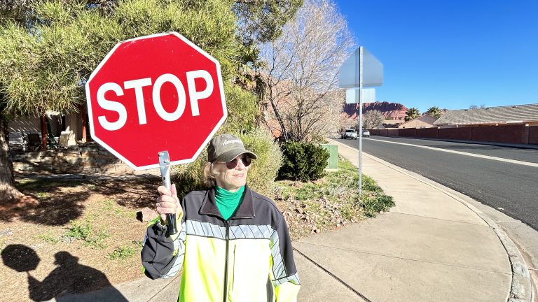 Crossing guard Sandy Ames, 81, stands at her usual spot on the corner of 400 East and 200 South in Ivins, Washington County, Feb. 29. She has been helping students for a generation and doesn't want to quit. 