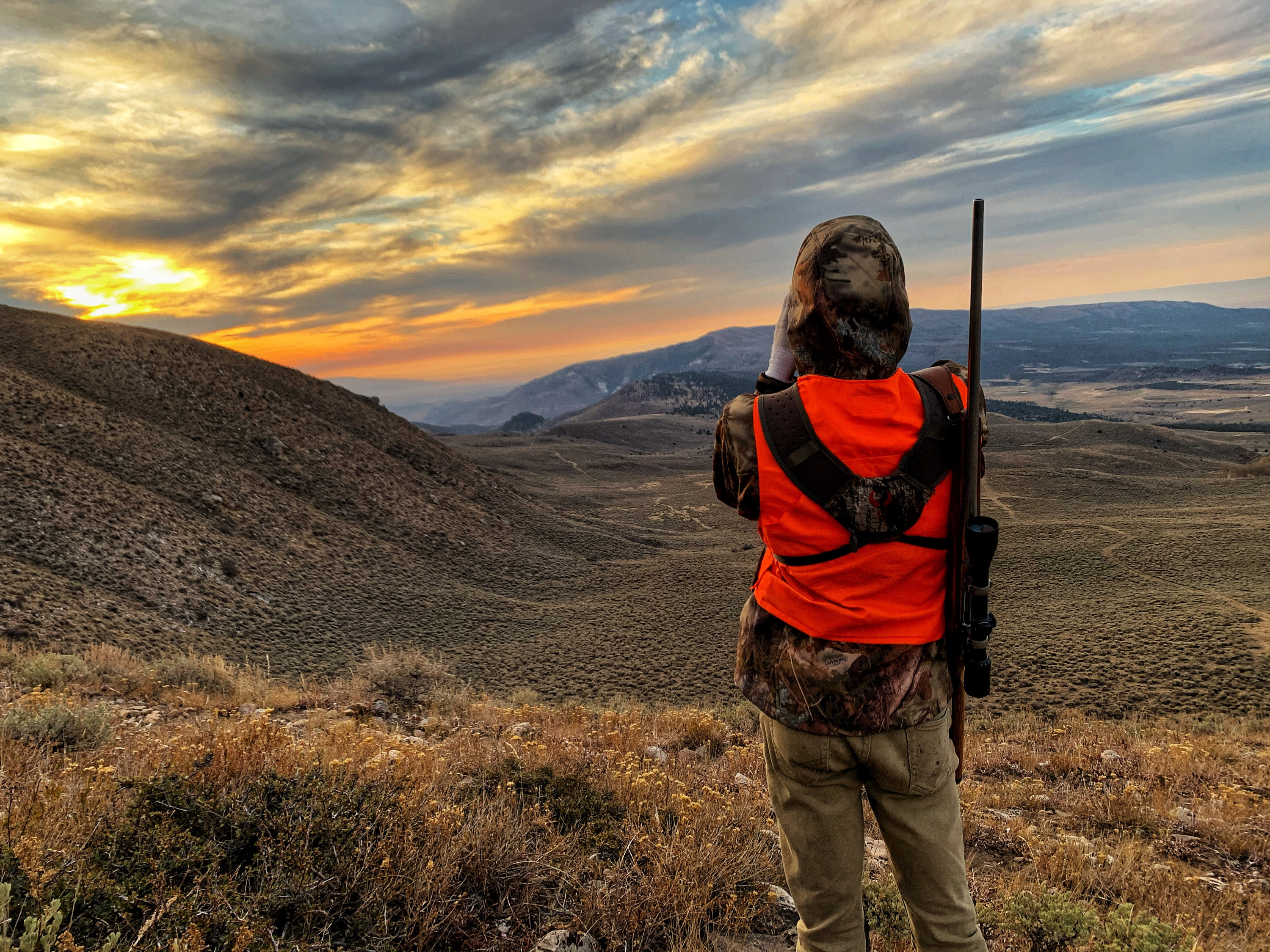 A hunter looks across a valley northwest of Vernal, just outside of the Ashley National Forest on Oct. 19, 2020. Utah lawmakers passed two bills with hunting changes this year, including new regulations tied to wearing orange.