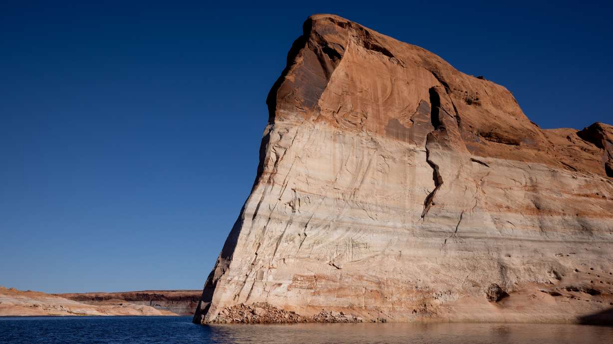 Lake Powell’s “bathtub ring,” a light-colored coating of mineral deposits left during periods of higher water on the reservoir, is seen on canyon walls on Oct. 6, 2022, near Bullfrog.