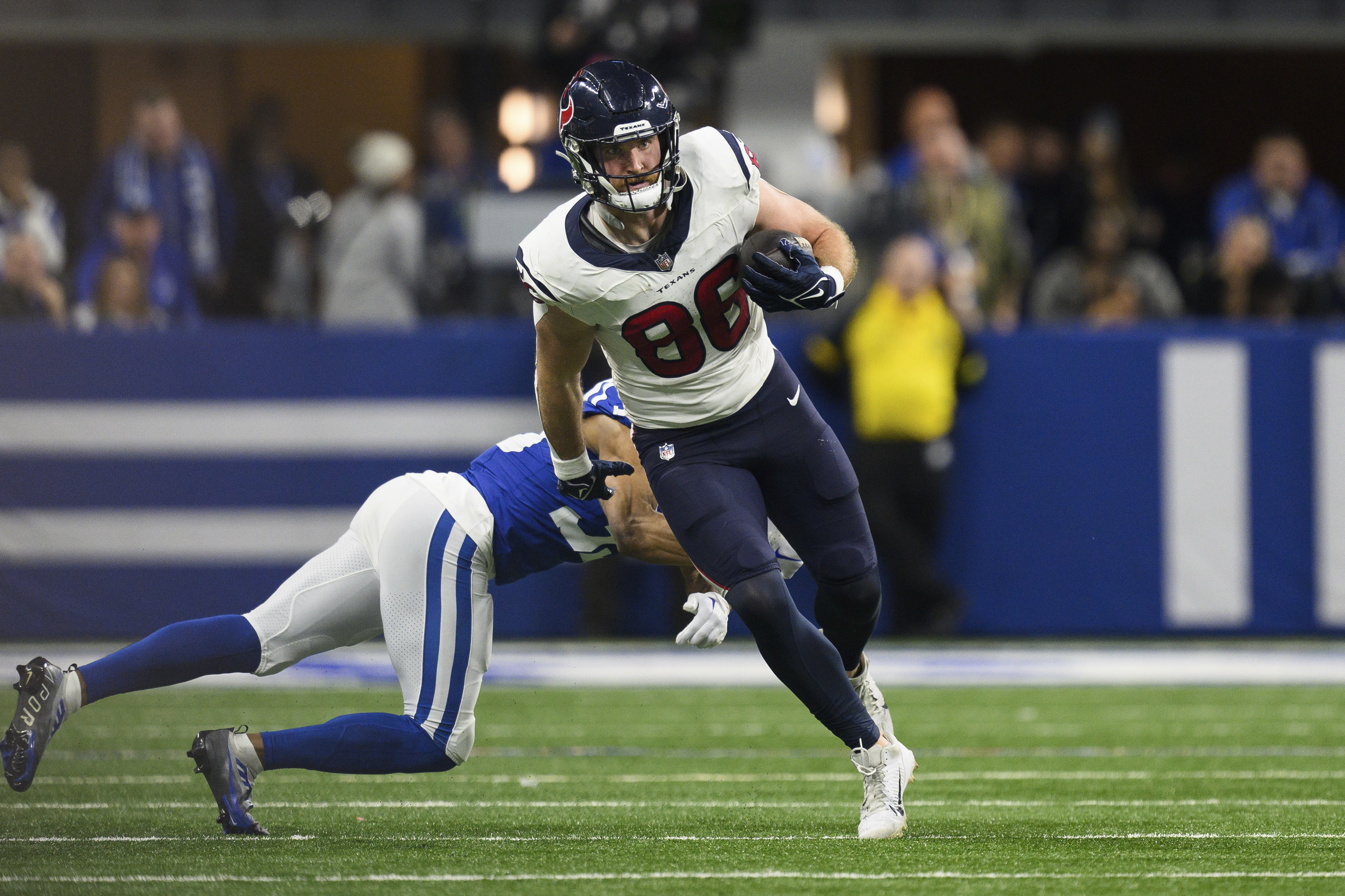 Houston Texans tight end Dalton Schultz (86) runs through the tackle of Indianapolis Colts cornerback Darrell Baker Jr. (39) during an NFL football game, Saturday, Jan. 6, 2024, in Indianapolis. Houston signed Schultz to a one-year, $6.25 million deal and got 59 catches for 635 yards and five TDs in the regular season and another TD in the playoffs.