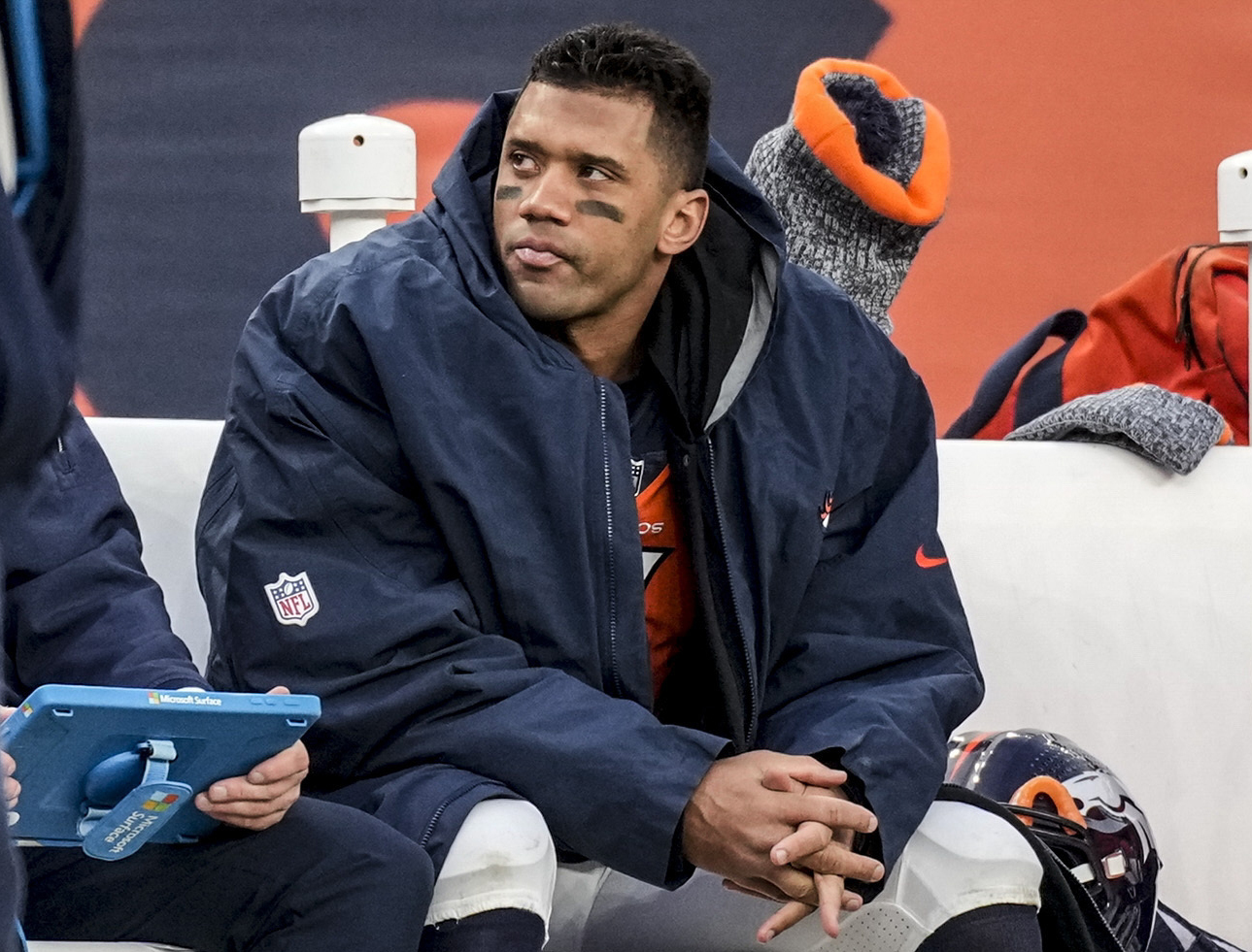 FILE - Denver Broncos quarterback Russell Wilson sits on the bench during the second half of an NFL football game against the Los Angeles Chargers, Sunday, Dec. 31, 2023, in Denver. Denver believed so strongly in Wilson that the Broncos gave him a five-year, $245 million extension before he played a game for them even though he had two years left on his deal.