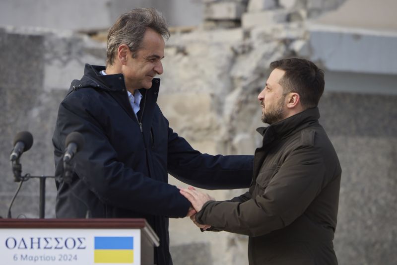 Ukrainian President Volodymyr Zelenskyy, right, and Greece's Prime Minister Kyriakos Mitsotakis shake hands, in Odesa, Ukraine, Wednesday.