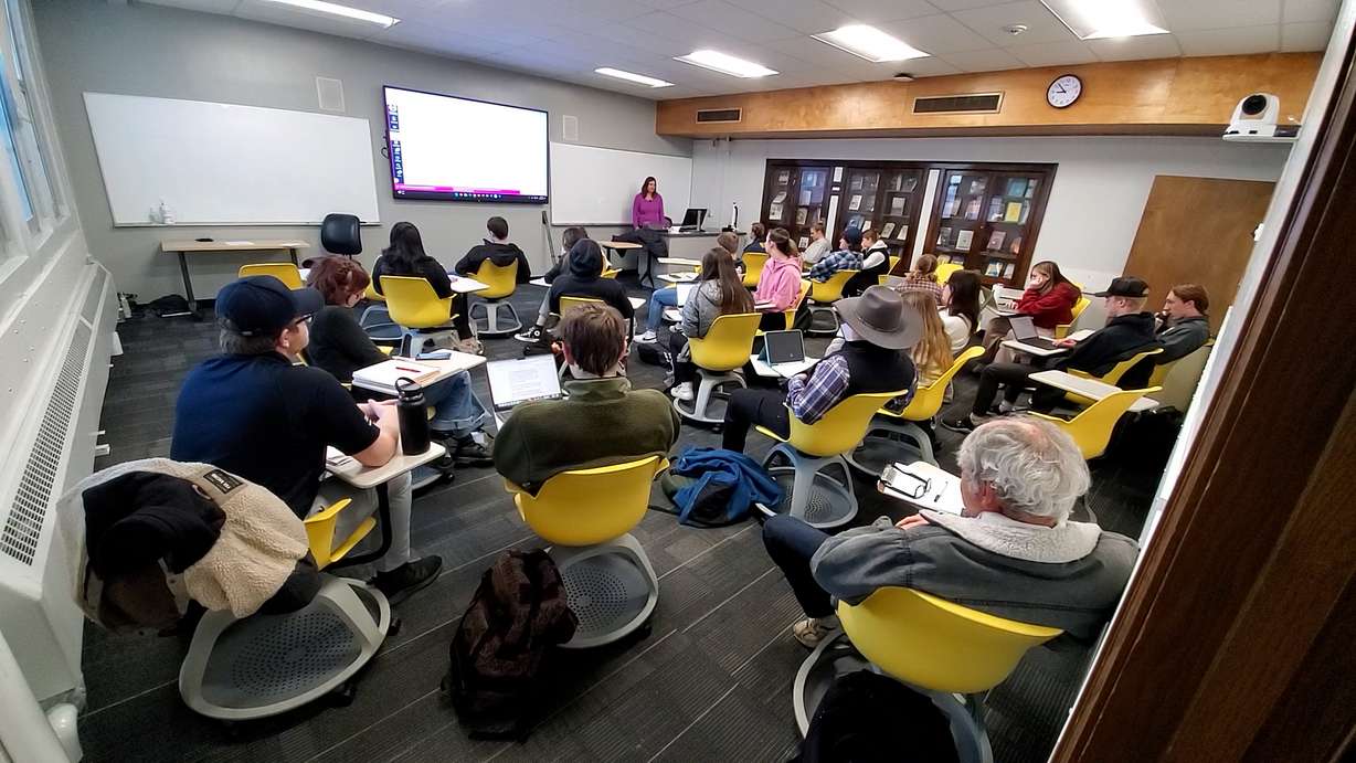 Shanan Ballam stands in front of a class at Utah State University, where she teaches poetry.