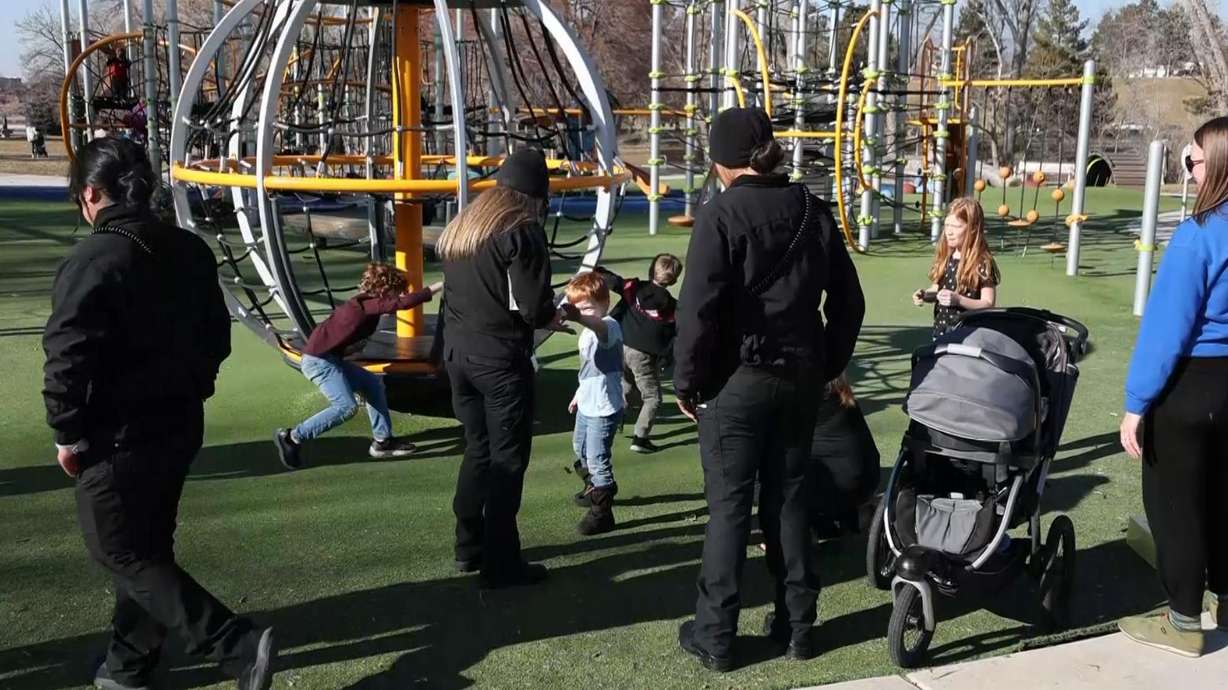 Specialist Debbie Findlay gives a young boy a sticker during PCRT outreach.