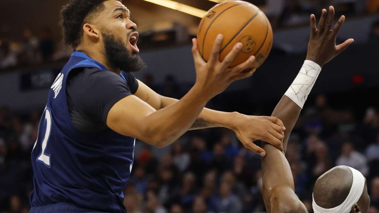 Minnesota Timberwolves forward Karl-Anthony Towns, left, goes to the basket against the Portland Trail Blazers in the first quarter of an NBA basketball game Monday, March 4, 2024, in Minneapolis.
