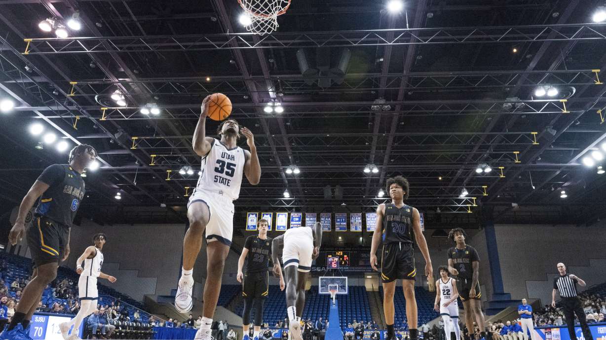 Utah State forward Nigel Burris (35) lays up a shot as San Jose State guard Latrell Davis (6) and forward Christian Wise (20) look on during the second half of an NCAA basketball game State Wednesday, March 6, 2024, in San Jose, Calif.
