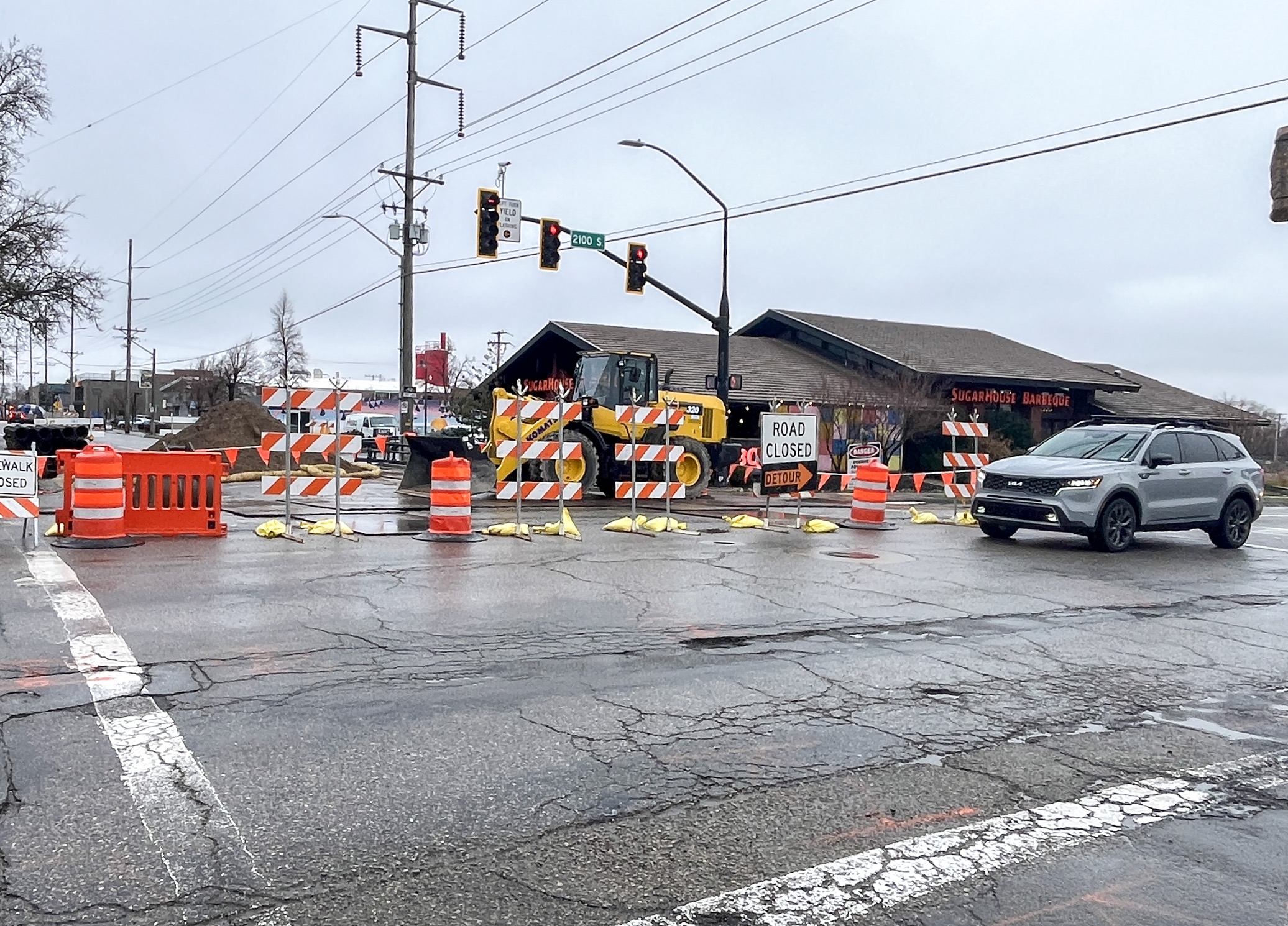 A vehicle moves past a partial closure of the 2100 South intersection with 900 East in Salt Lake City on Thursday.