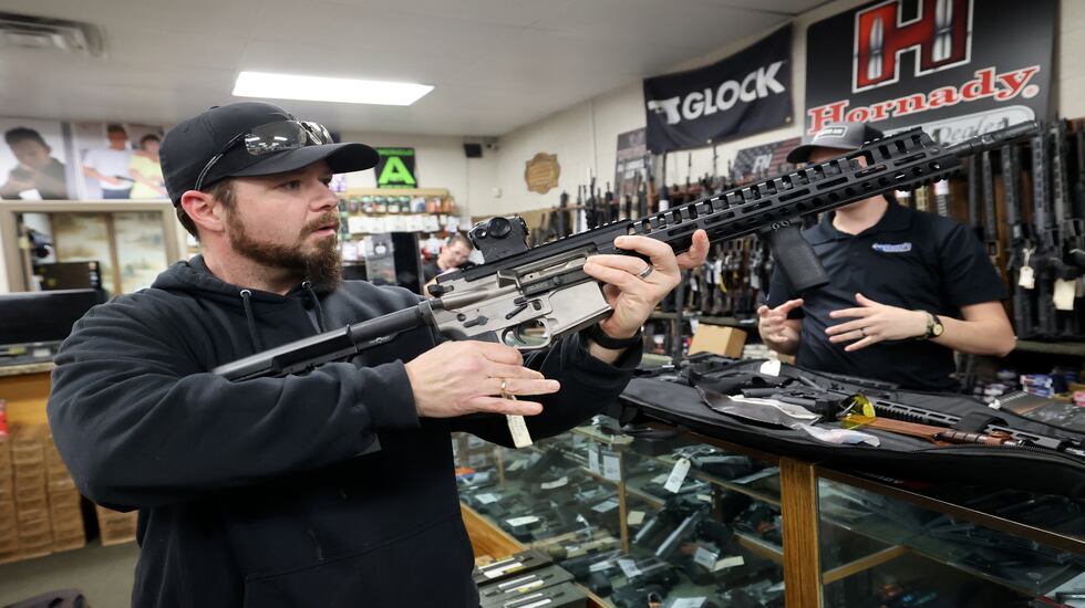 Les Saibo looks at accessories for his AR-15 at Doug’s Shoot’n Sports in Taylorsville on Thursday. Saibo also ordered a new handgun at the shop.