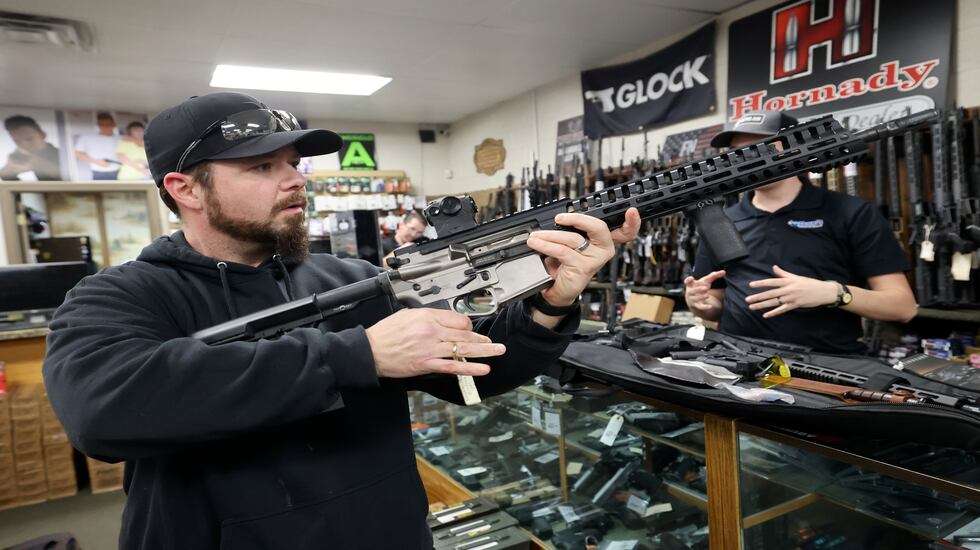 Les Saibo looks at accessories for his AR-15 at Doug’s Shoot’n Sports in Taylorsville on Thursday. Saibo also ordered a new handgun at the shop.