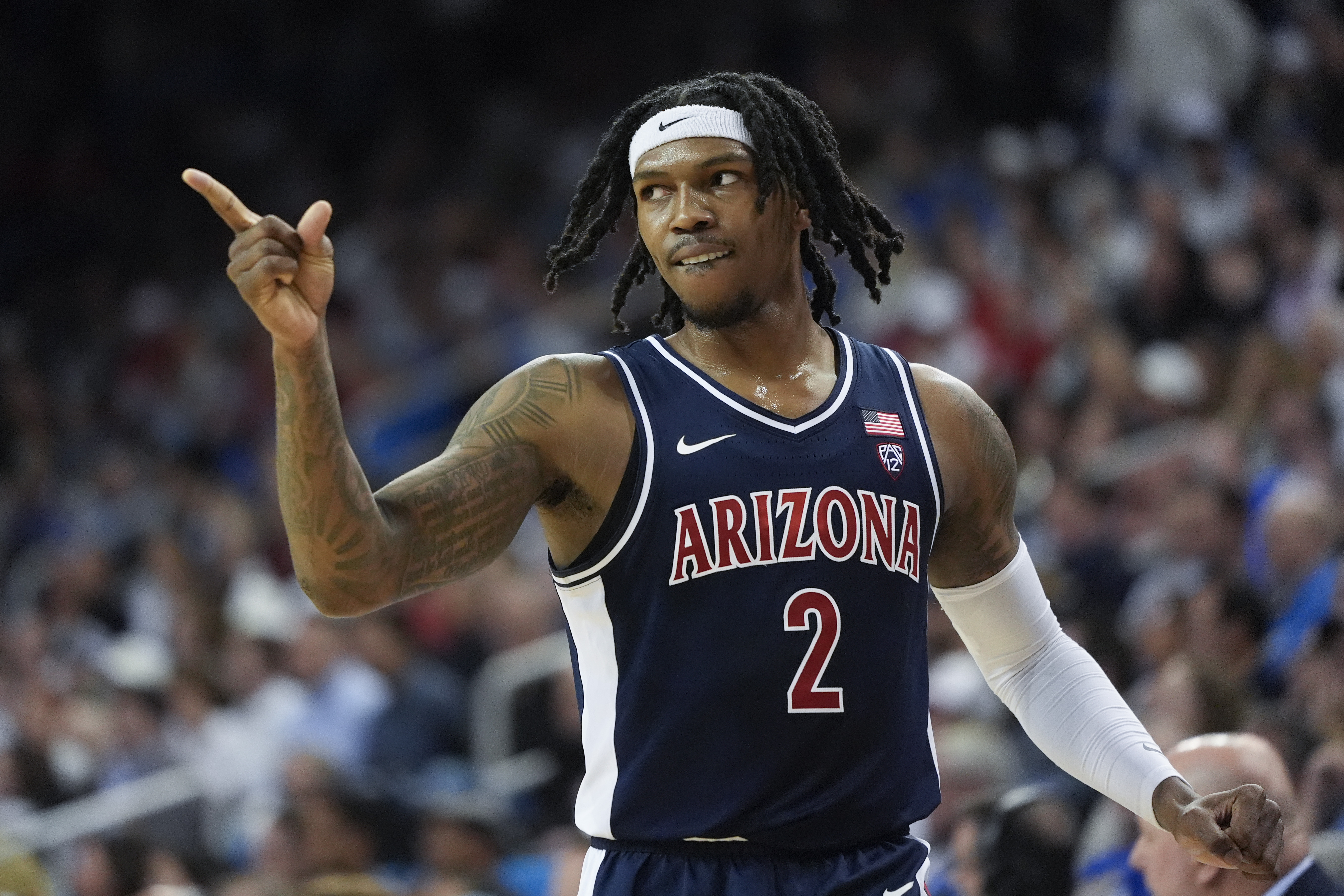 Arizona guard Caleb Love (2) points to a teammate during the first half of an NCAA college basketball game against UCLA in Los Angeles, Thursday, March 7, 2024.
