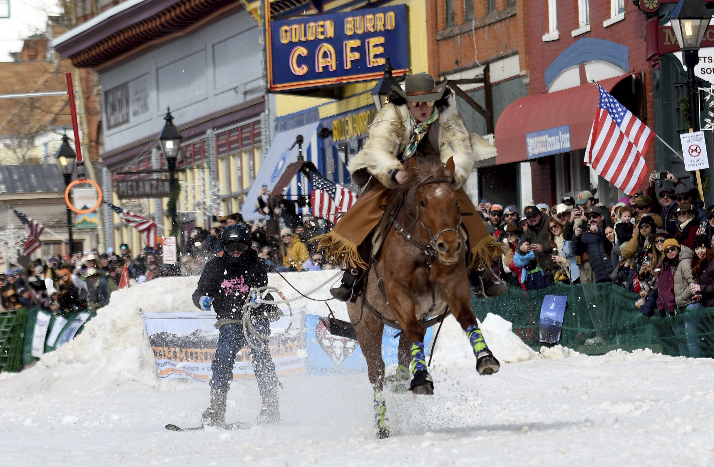 A skijoring team competes in Leadville, Colo., on Saturday, March 2, 2024. Skijoring draws its name from the Norwegian word skikjoring, meaning "ski driving." It started as a practical mode of transportation in Scandinavia and became popular in the Alps around 1900. Today's sport features horses at full gallop towing skiers by rope over jumps and around obstacles as they try to lance suspended hoops with a baton, typically a ski pole that's cut in half.