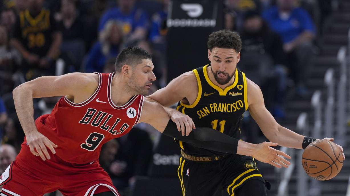 Chicago Bulls center Nikola Vucevic, left, tries to poke the ball away from Golden State Warriors guard Klay Thompson during the first half of an NBA basketball game Thursday, March 7, 2024, in San Francisco.