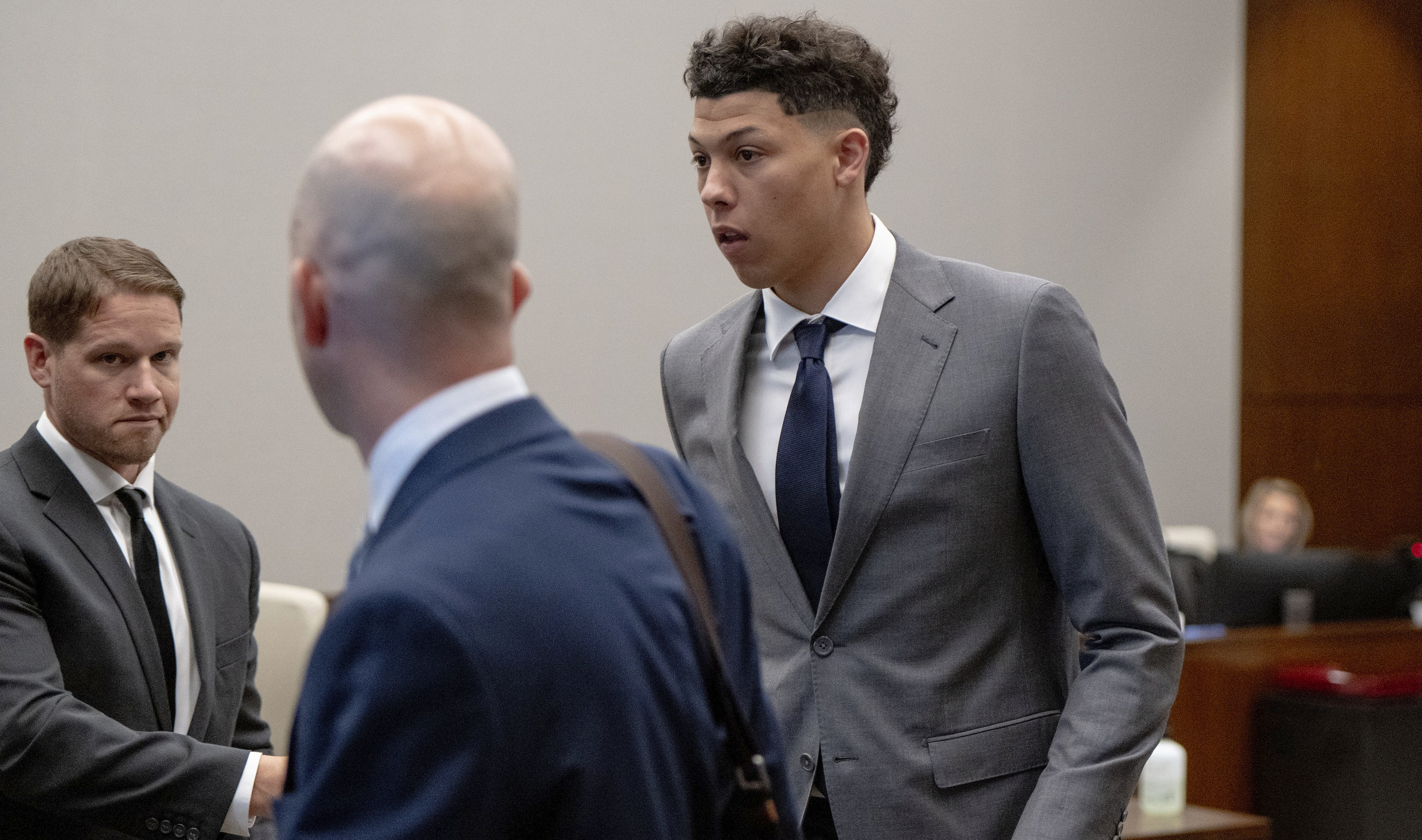 FILE - Jackson Mahomes, right, leaves the courtroom following a bond motion hearing in Johnson County District Court, May 16, 2023, in Olathe, Kan. The younger brother of Super Bowl-winning Kansas City Chiefs quarterback Patrick Mahomes has been sentenced to six months' probation in a case alleging an assault on a woman. Jackson Mahomes, 23, appeared Thursday, March 7, 2024, for his sentencing hearing via video conference and pleaded guilty to a single misdemeanor count of battery, according to online court records. 