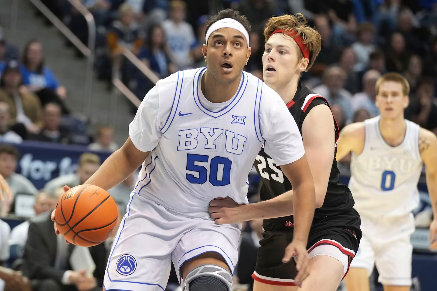 BYU center Aly Khalifa drives to the basket past Denver forward Touko Tainamo during game Dec. 13, 2023, in Provo. Khalifa is one of three Muslim players on this year's BYU roster, who will begin observing Ramadan on Sunday.