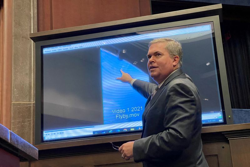 Deputy director of U.S. Naval Intelligence Scott Bray points to a video of a 'flyby' as he testifies before a House Intelligence Counterterrorism, Counterintelligence, and Counterproliferation Subcommittee hearing about "Unidentified Aerial Phenomena,"  in the first open congressional hearing on 'UFOs' in more than a half-century, on Capitol Hill in Washington, May 17, 2022. A new report concludes that most sightings after World War II were misidentified ordinary objects and phenomena.