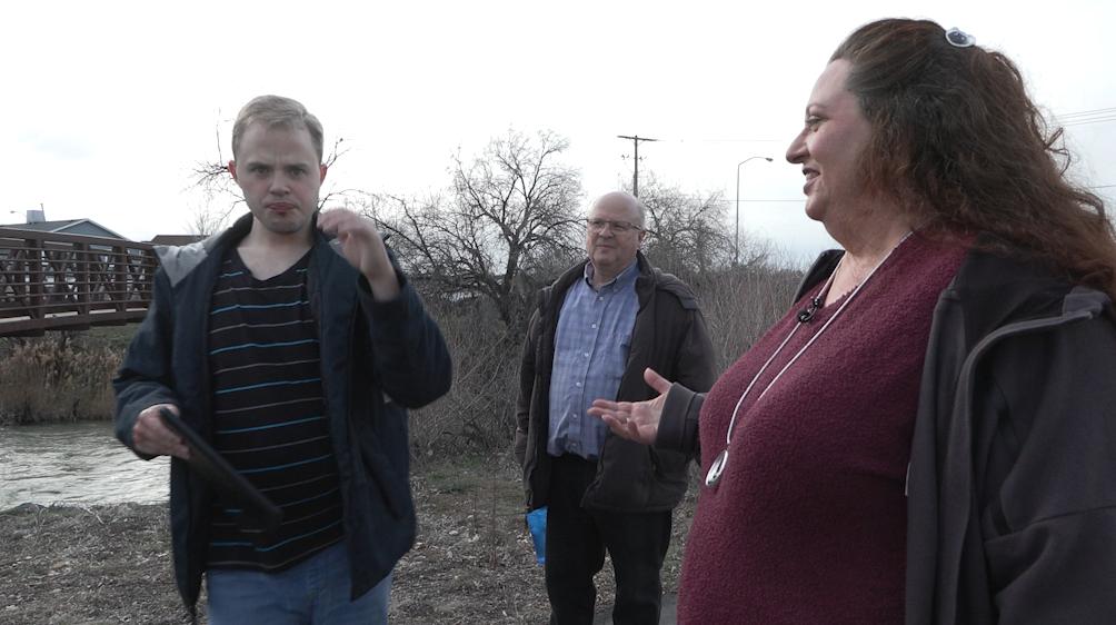 Jarrett Lyon walks with his parents, Blair Lyon and Kara Walker-Lyon, on the Jordan River Trail. The Lyons are speaking out after a former caregiver was recently sentenced to community service for losing their nonverbal son last summer.