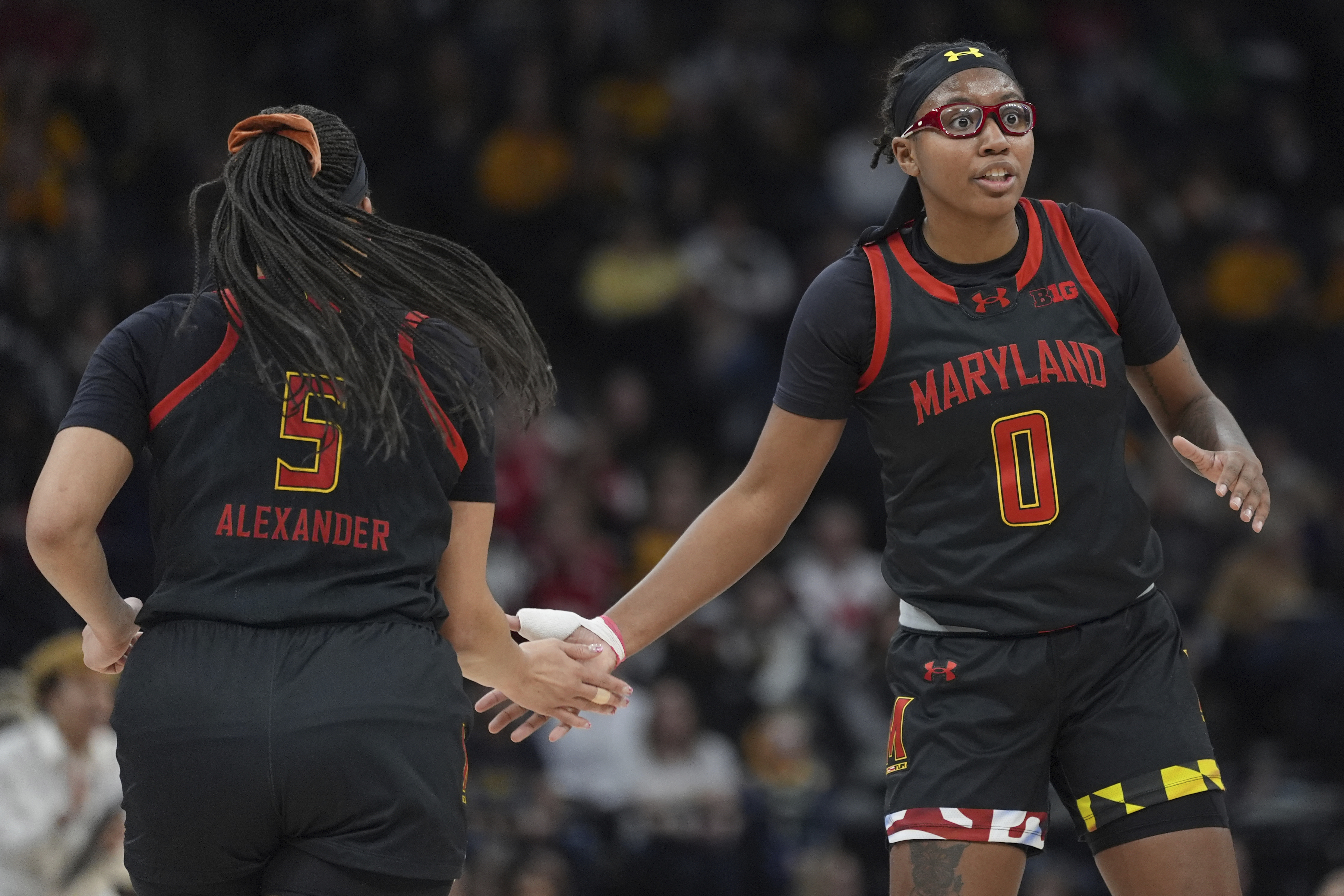 Maryland guards Brinae Alexander (5) and Shyanne Sellers (0) high-five during the first half of an NCAA college basketball quarterfinal game against Ohio State at the Big Ten women's tournament Friday, March 8, 2024, in Minneapolis. Maryland upsets No. 3 Ohio State 82-61.