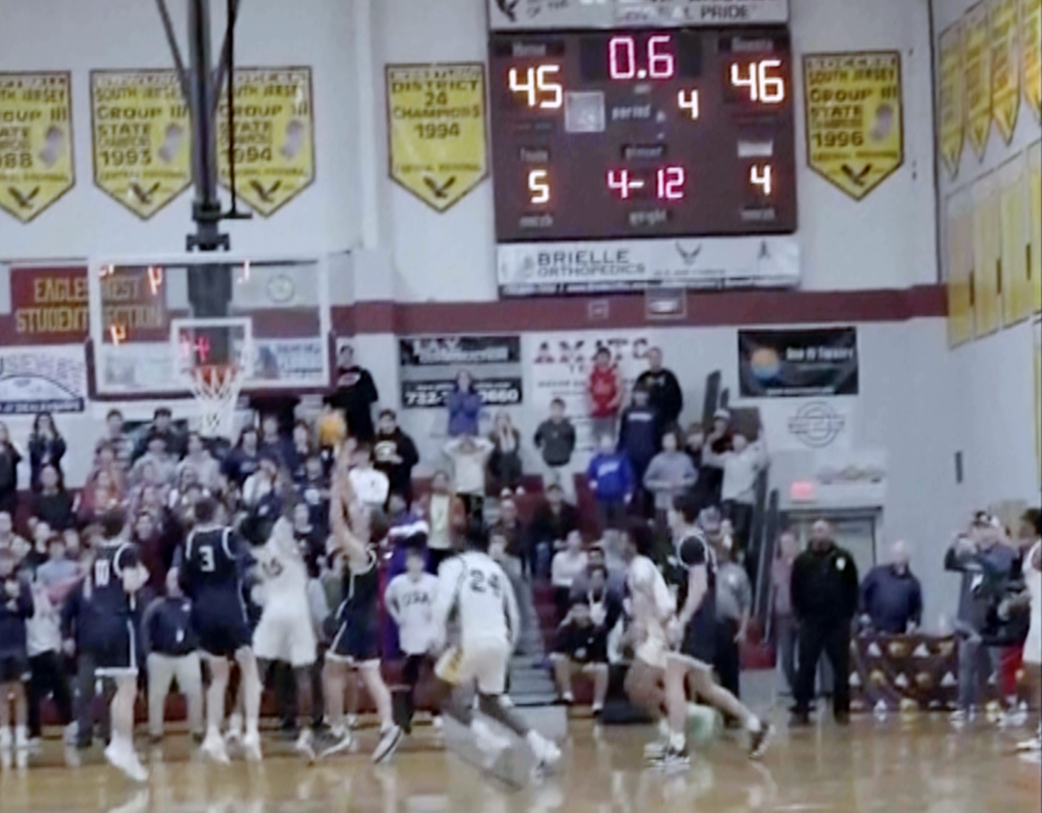 In this image taken from video provided by Joshua Clyburn, Manasquan's Griffin Linstra, center left, shoots as the clock winds down in the NJSIAA Group Tournament semifinal sound group 2 high school basketball game against Camden, Tuesday, March 5, 2024, in Berkley Township, N.J. Manasquan initially was declared the winner, however, the call was soon overturned when the referees discussed the shot and concluded it came after the buzzer, giving Camden a 46-45 win. 