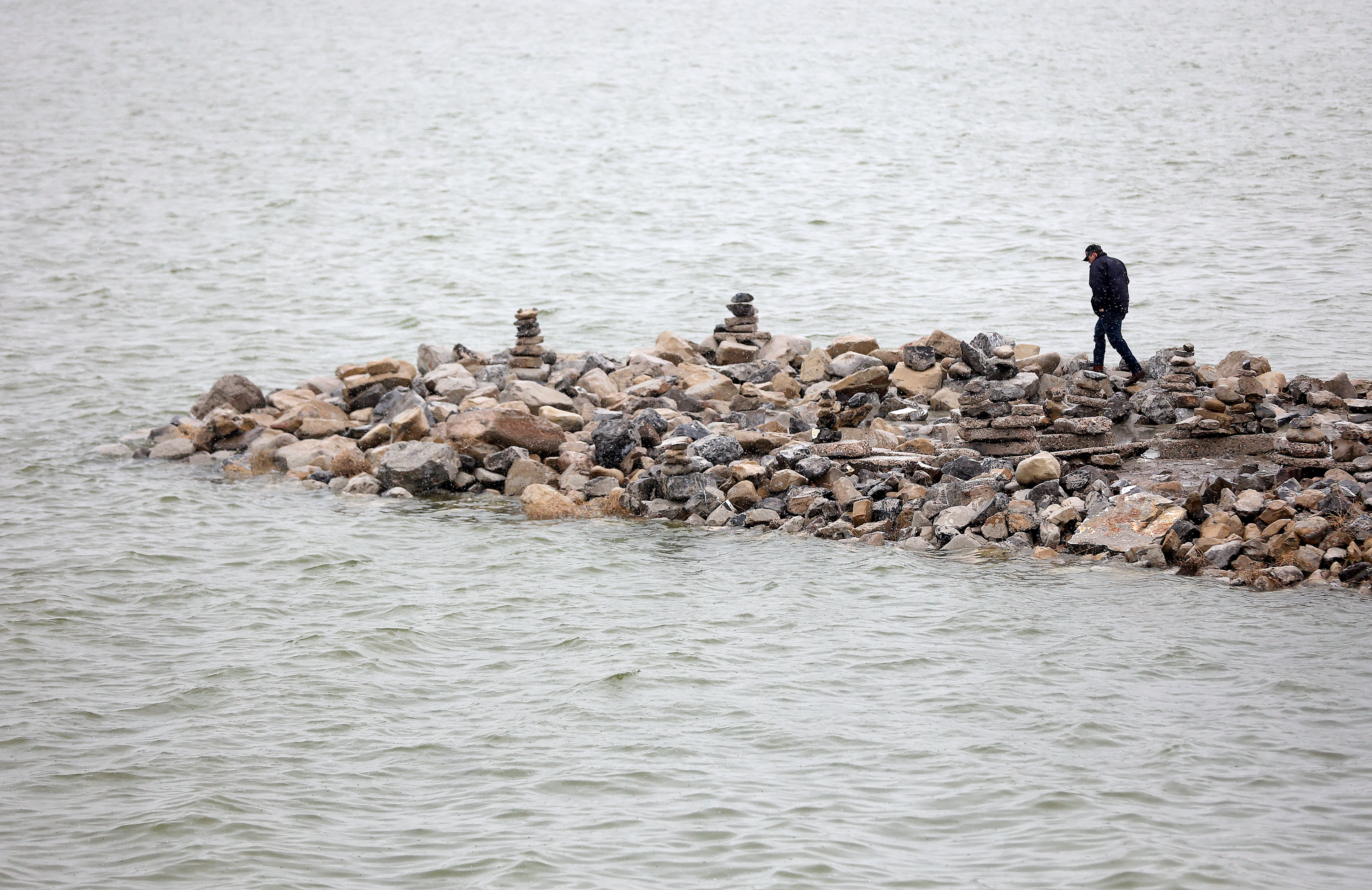A man explores a jetty in the Great Salt Lake at Great Salt Lake State Park in Salt Lake County on Feb. 7. Artist submissions opened Thursday for the "Wake the Great Salt Lake" art contest, that aims to raise awareness about the struggling lake.