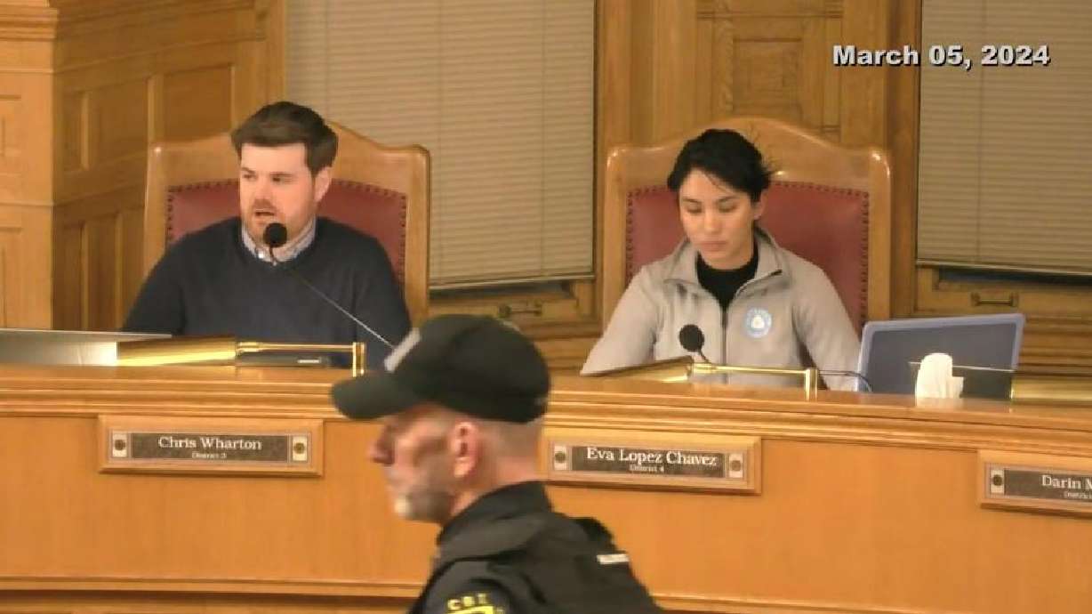 An officer prepares to assist in clearing the audience from the Salt Lake City Council chambers on Tuesday. A council decision at the meeting limiting the public comment period at gatherings to an hour prompted a vocal backlash from some.
