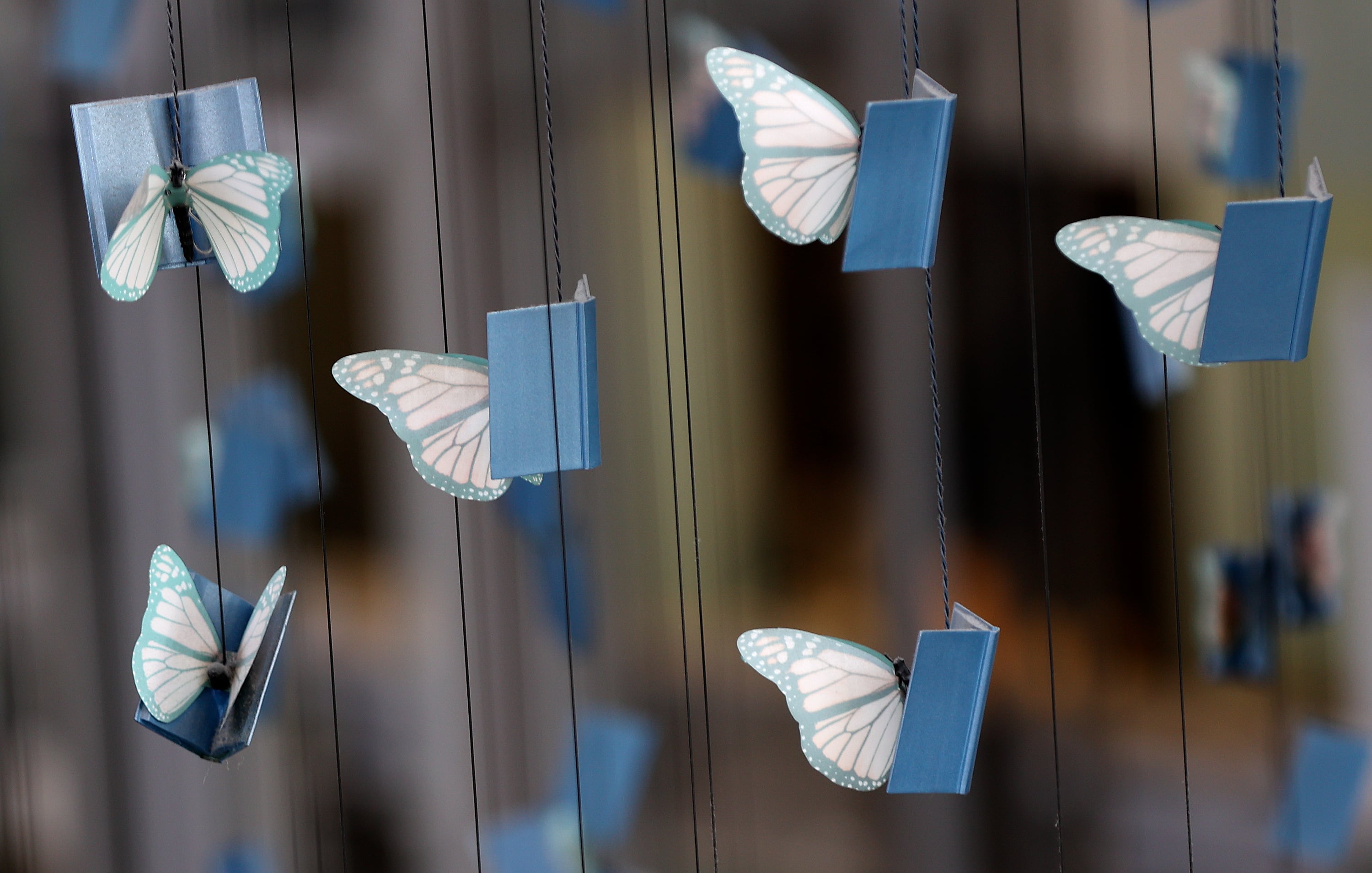Butterflies reading books are part of a hanging sculpture at the City Library in Salt Lake City on Friday.