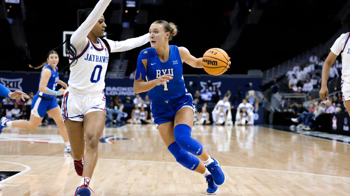 BYU guard Amari Whiting drives to the rim against Kansas during a Big 12 women's basketball tournament opener for both teams, Friday, March 8, 2024 at the T-Mobile Center in Kansas City, Mo.