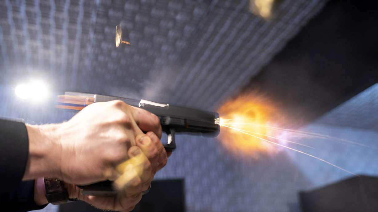 A semi-automatic pistol with a conversion device installed making it fully automatic is fired as four empty shell casings fly out of the weapon, at the Bureau of Alcohol, Tobacco, Firearms, and Explosives, National Services Center, March 2, 2023, in Martinsburg, W.Va.