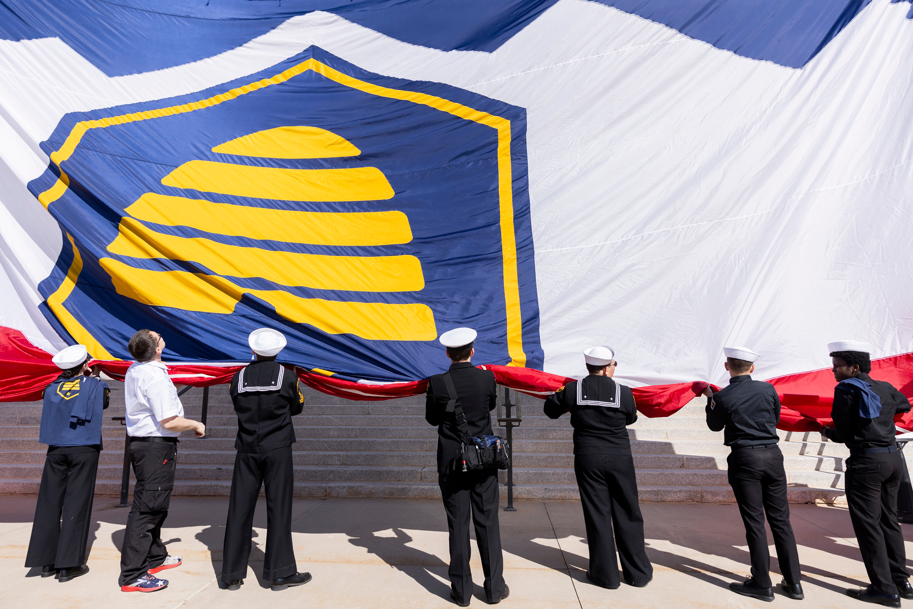 The military color guard rolls up the new state flag after a gathering to commemorate Utah Flag Day at the state Capitol in Salt Lake City on Saturday.