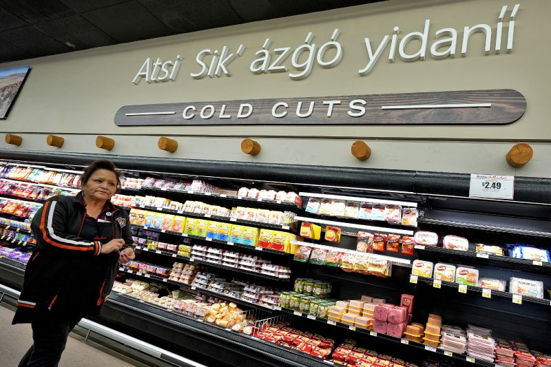 Reva Hoover, manager of Bashas' supermarket, walks the aisles of her store, March 4, in Tuba City, Ariz. The grocery store sits along a stretch of highway that forms a de facto border between the Navajo and Hopi Indian reservations and two time zones. 