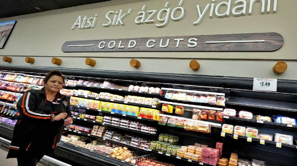 Reva Hoover, manager of Bashas' supermarket, walks the aisles of her store, March 4, in Tuba City, Ariz. The grocery store sits along a stretch of highway that forms a de facto border between the Navajo and Hopi Indian reservations and two time zones.